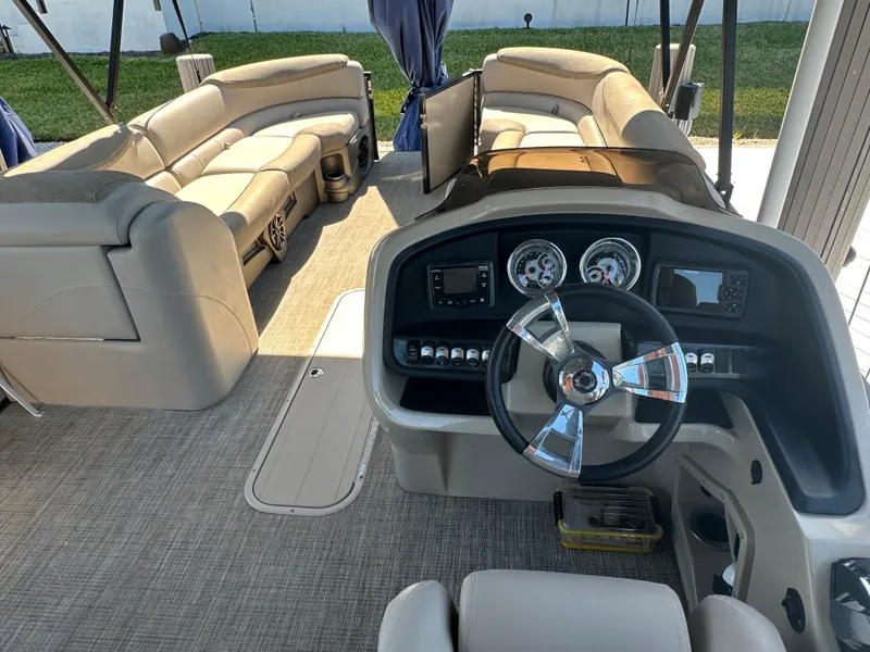 Slide: The Image of 2020 Avalon Catalina Platinum Quad Lounger interior with steering wheel and plush seating. - 17