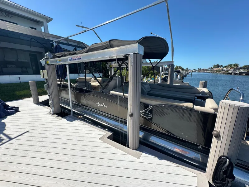 Slide: The Image of 2020 Avalon Catalina Platinum Quad Lounger boat docked by waterfront. - 20