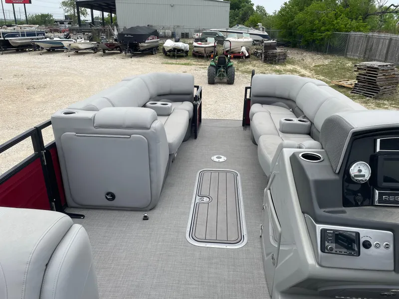 Slide: The Image of 2023 Regency 250DL3 pontoon boat interior with gray seating and control panel. - 19