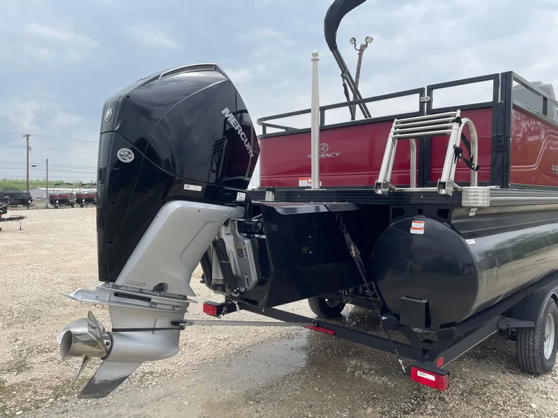 Slide: The Image of 2023 Regency 250DL3 boat with Mercury outboard motor on a trailer. - 3