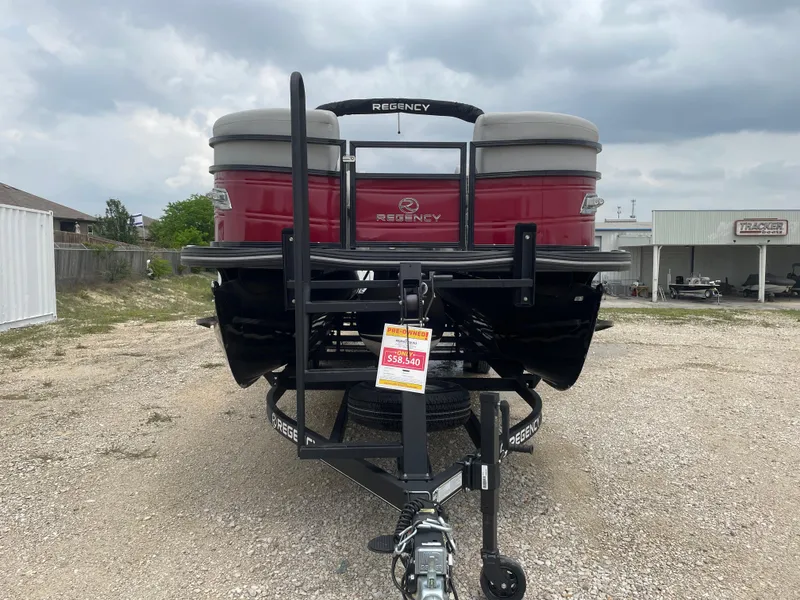 Slide: The Image of 2023 Regency 250DL3 pontoon boat on trailer, displayed outdoors under cloudy sky. - 8