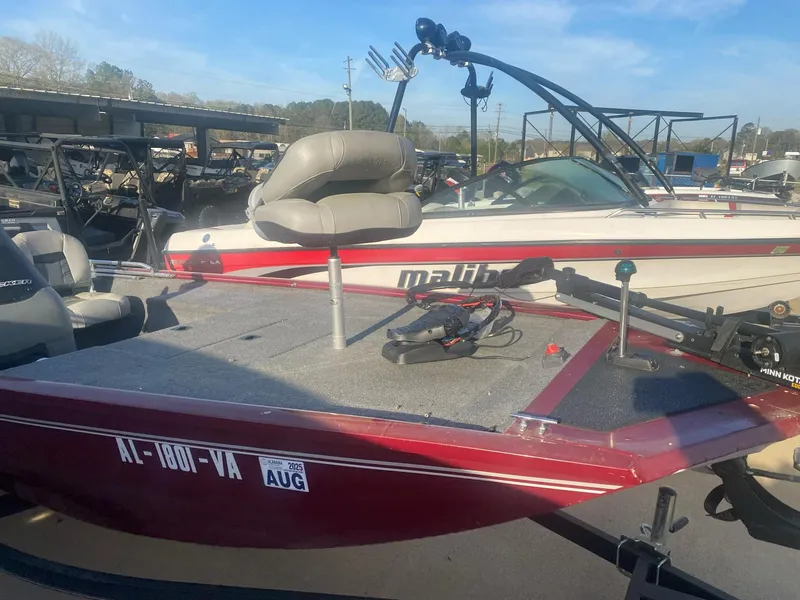 Slide: The Image of 2018 Tracker Pro 170 boat with seating, docked beside another vessel. - 2