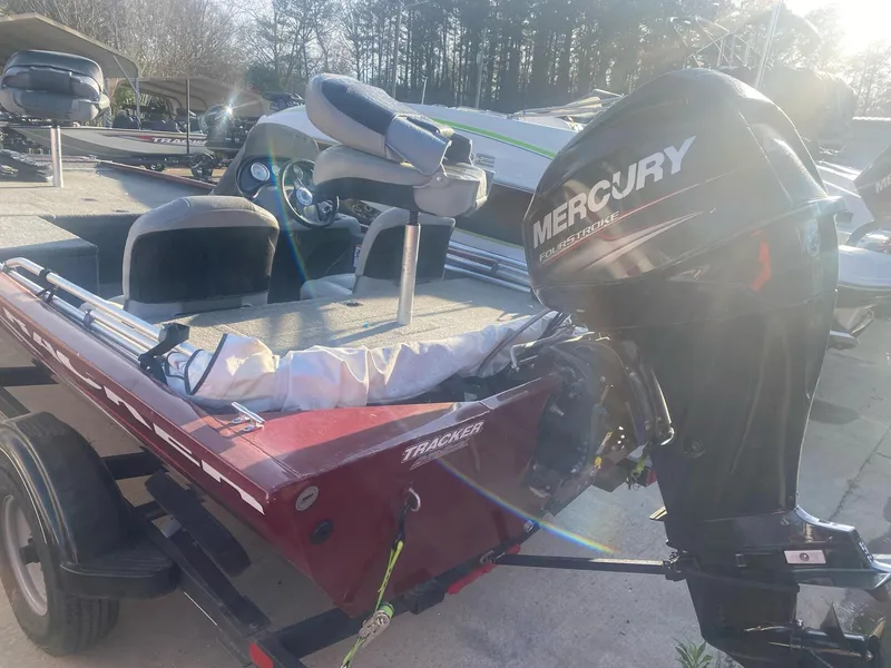 Slide: The Image of 2018 Tracker Pro 170 boat with Mercury outboard motor, parked on a trailer. - 3