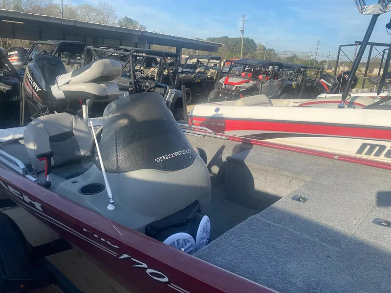Slide: The Image of 2018 Tracker Pro 170 boat in a storage area, surrounded by other boats. - 4