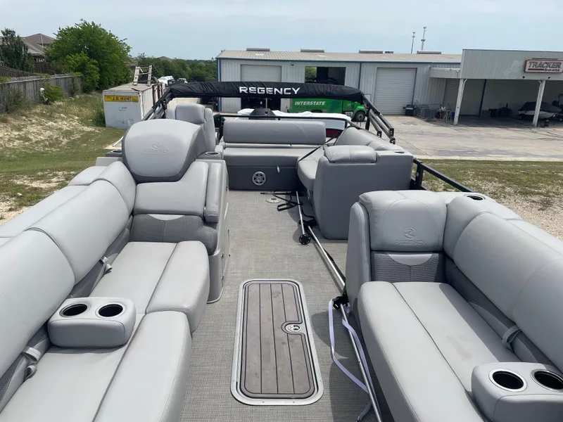 Slide: The Image of 2023 Regency 250DL3 pontoon boat with spacious seating and modern design. - 11