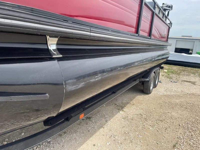 Slide: The Image of 2023 Regency 250DL3 pontoon boat on trailer, featuring sleek black and red design. - 9