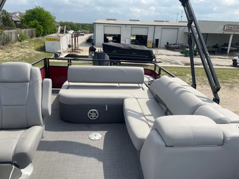 Slide: The Image of 2023 Regency 250DL3 pontoon boat on trailer, featuring red and black design. - 13