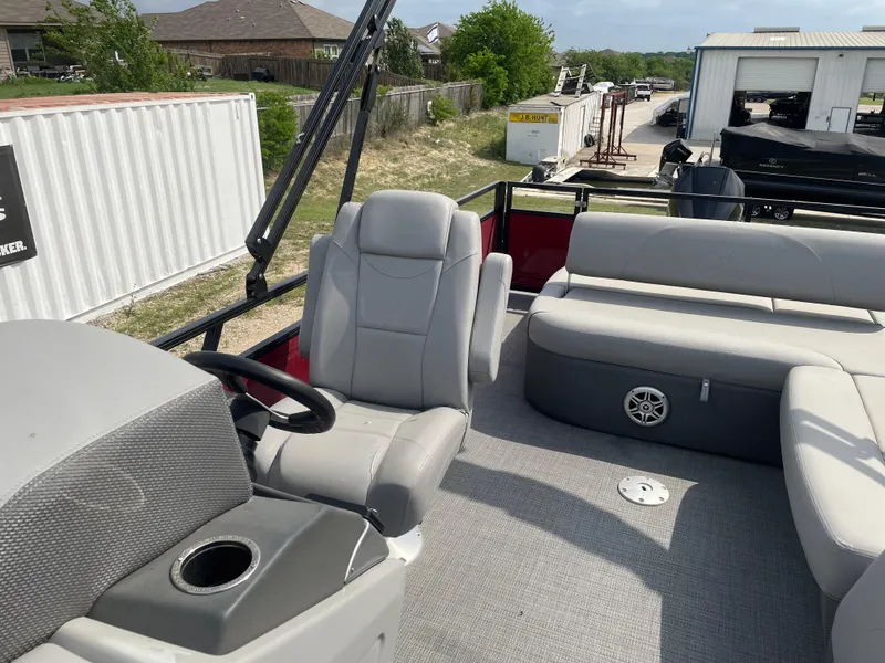 Slide: The Image of 2023 Regency 250DL3 pontoon boat interior with spacious gray seating and deck. - 14