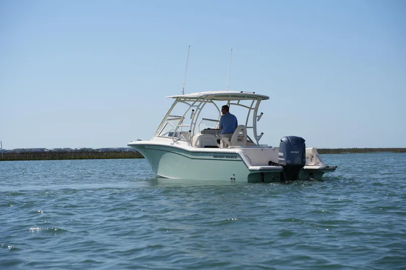 Slide: The Image of 2021 Grady-White Freedom 235 boat cruising on calm water. - 10