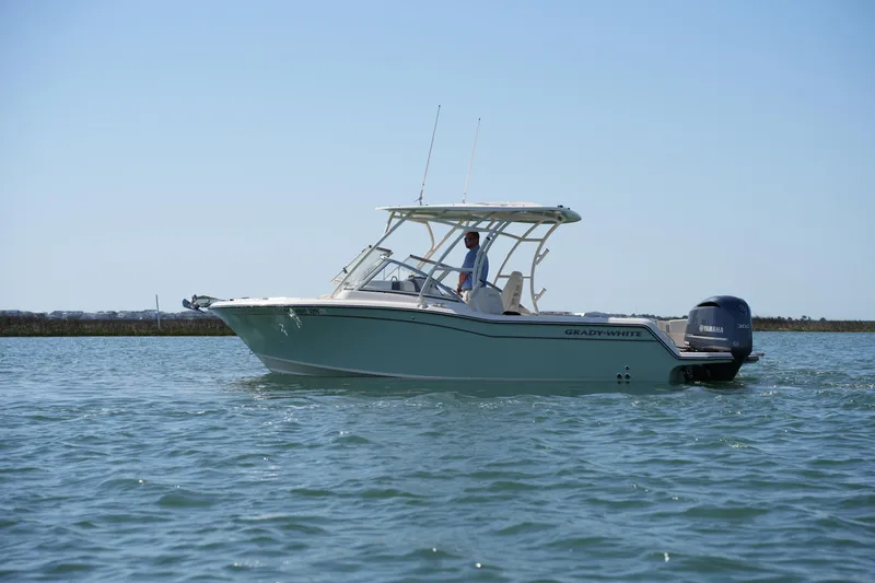 Slide: The Image of 2021 Grady-White Freedom 235 boat on calm water, side view. - 13