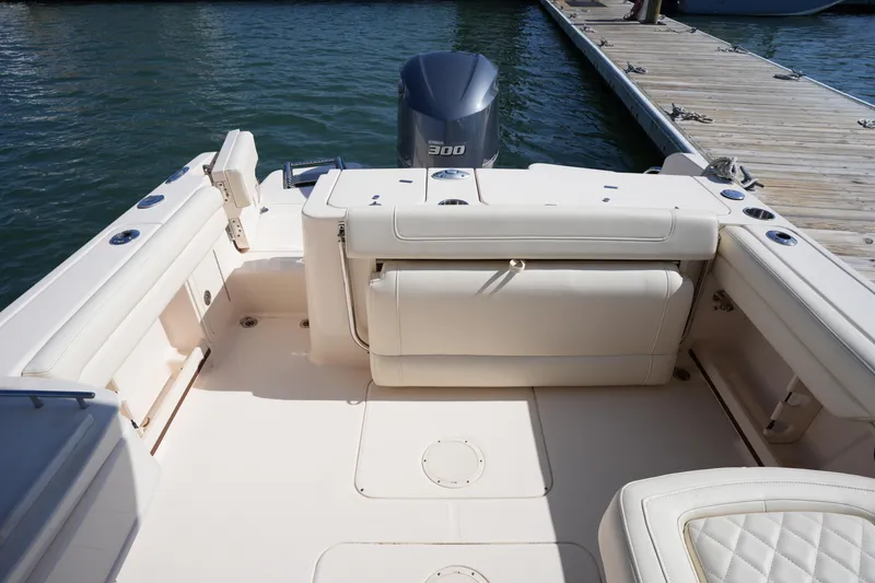 Slide: The Image of 2021 Grady-White Freedom 235 boat interior with Yamaha 300 engine, docked by wooden pier. - 15