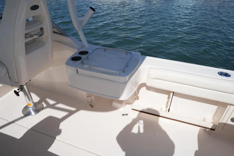 Slide: The Image of 2021 Grady-White Freedom 235 boat interior with seating and storage, on calm water. - 19