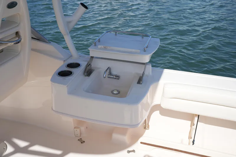 Slide: The Image of 2021 Grady-White Freedom 235 boat sink and seating area by the water. - 20