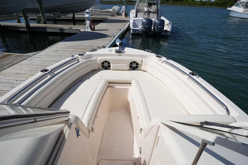 Slide: The Image of 2021 Grady-White Freedom 235 boat docked, showcasing spacious seating and sleek design. - 32