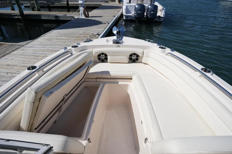 Slide: The Image of 2021 Grady-White Freedom 235 boat interior with spacious seating and docked at marina. - 33