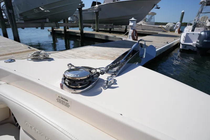 Slide: The Image of 2021 Grady-White Freedom 235 boat docked, showcasing anchor system and deck details. - 34