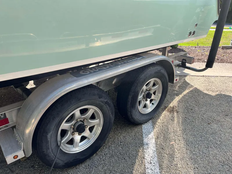Slide: The Image of 2021 Grady-White Freedom 235 boat on a dual-axle trailer, parked on asphalt. - 36