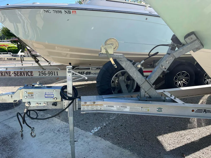 Slide: The Image of 2021 Grady-White Freedom 235 boat on trailer, parked in a marina service area. - 37