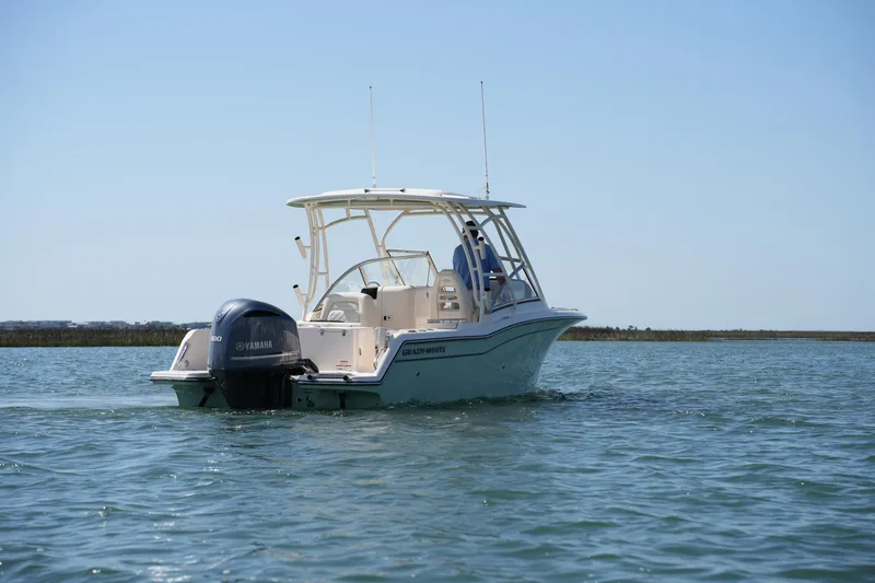 Slide: The Image of 2021 Grady-White Freedom 235 boat cruising on calm waters. - 6