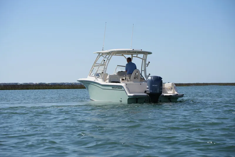 Slide: The Image of 2021 Grady-White Freedom 235 boat cruising on open water. - 9