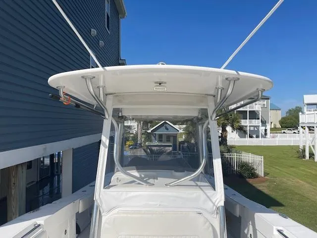 Slide: The Image of 2007 Southport 28 CC boat with T-top, docked near coastal homes. - 12