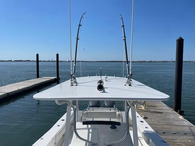 Slide: The Image of 2007 Southport 28 CC boat docked, featuring fishing rods and clear blue sky. - 13