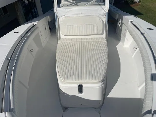 Slide: The Image of 2007 Southport 28 CC boat interior with white cushioned seating and spacious deck. - 15