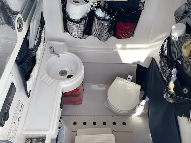 Slide: The Image of 2007 Southport 28 CC boat interior with sink, toilet, and storage compartments. - 23