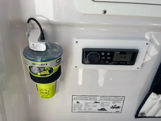 Slide: The Image of Emergency beacon and radio panel on 2007 Southport 28 CC boat dashboard. - 24