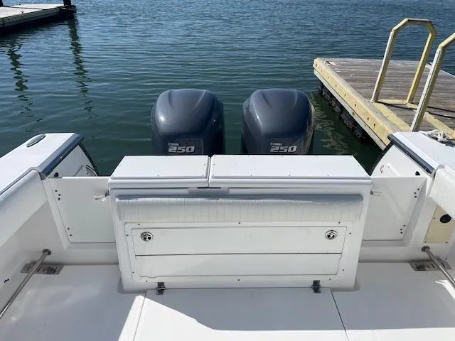 Slide: The Image of 2007 Southport 28 CC boat with twin 250 engines docked by a pier. - 26