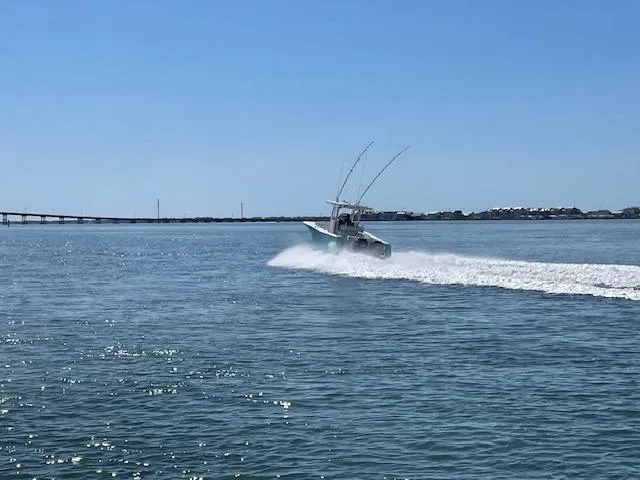 Slide: The Image of 2007 Southport 28 CC boat speeding on open water under clear blue sky. - 31
