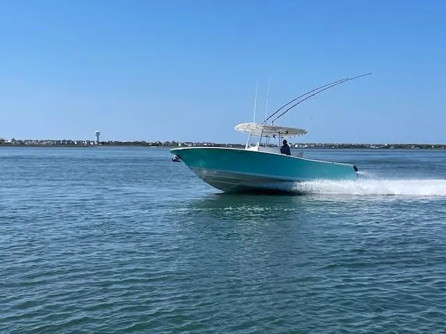 Slide: The Image of 2007 Southport 28 CC boat cruising on open water under clear blue sky. - 34