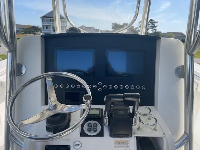 Slide: The Image of Console of a 2007 Southport 28 CC boat with dual screens and steering wheel. - 6