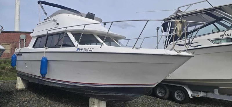 Slide: The Image of 1994 Bayliner 2858 Cierra boat on trailer, docked with blue fenders. - 1
