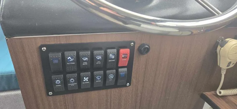 Slide: The Image of Control panel of a 1994 Bayliner 2858 Cierra boat with various switches and a steering wheel. - 11