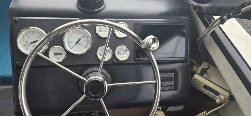 Slide: The Image of Steering wheel and dashboard of 1994 Bayliner 2858 Cierra boat with gauges and controls. - 12