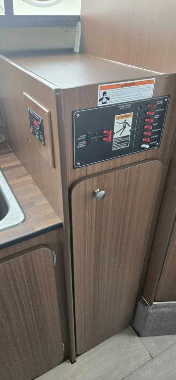 Slide: The Image of 1994 Bayliner 2858 Cierra interior control panel with wood finish. - 14