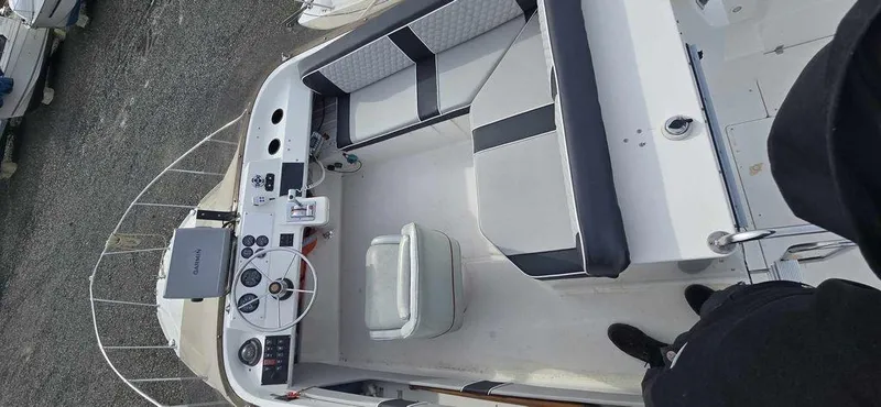 Slide: The Image of 1994 Bayliner 2858 Cierra boat interior with seating and control panel, viewed from above. - 3