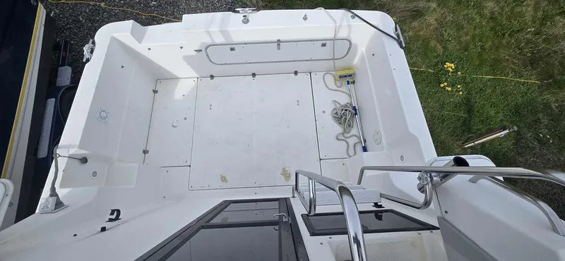 Slide: The Image of 1994 Bayliner 2858 Cierra boat deck, spacious and clean, with visible railing and storage compartments. - 4