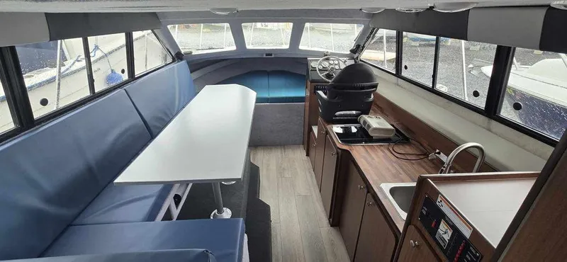 Slide: The Image of Interior of 1994 Bayliner 2858 Cierra boat with seating, table, and kitchenette. - 5