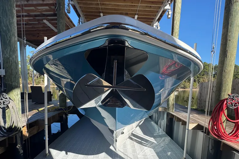 Slide: The Image of 2016 Everglades 435 Center Console boat docked, showcasing sleek hull design. - 11