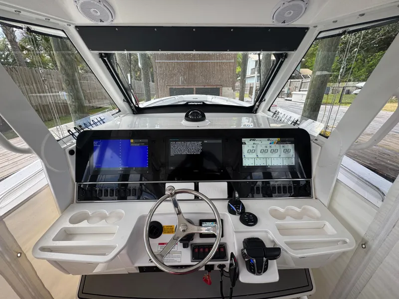 Slide: The Image of 2016 Everglades 435 Center Console helm with advanced navigation displays and controls. - 17