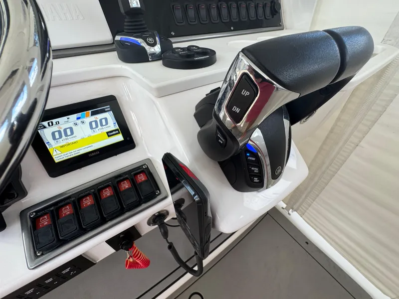 Slide: The Image of Control panel of a 2016 Everglades 435 Center Console boat with throttle and display. - 19
