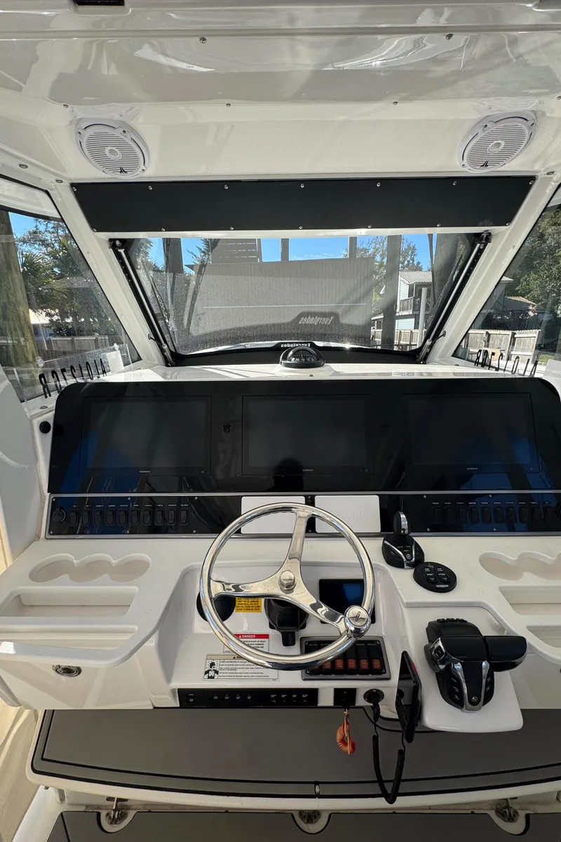 Slide: The Image of 2016 Everglades 435 Center Console helm with modern controls and steering wheel. - 20