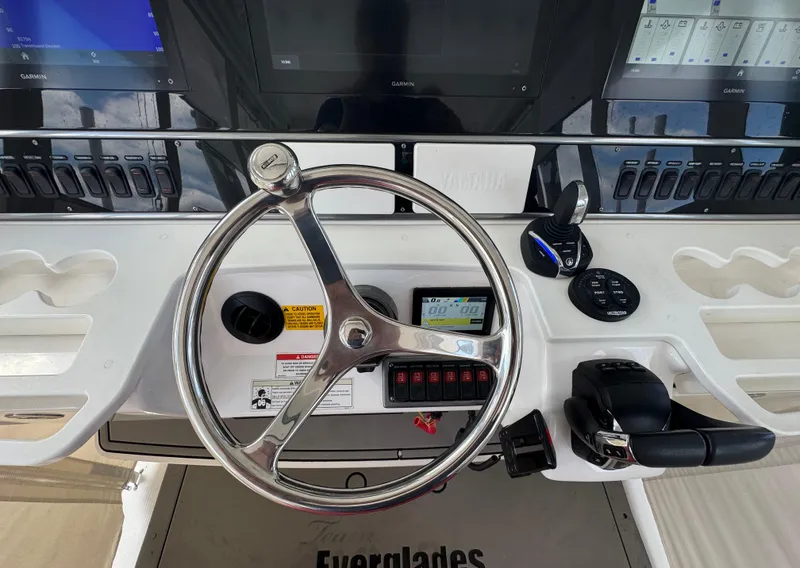 Slide: The Image of Steering wheel and controls of a 2016 Everglades 435 Center Console boat. - 23
