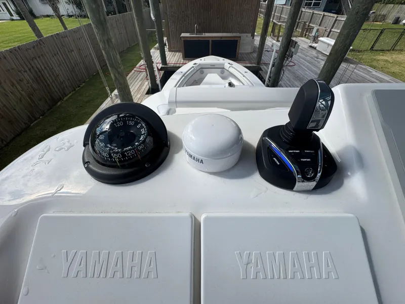 Slide: The Image of 2016 Everglades 435 Center Console helm with Yamaha controls and compass. - 26