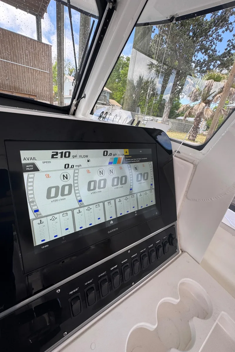 Slide: The Image of 2016 Everglades 435 Center Console dashboard with digital display and controls. - 28
