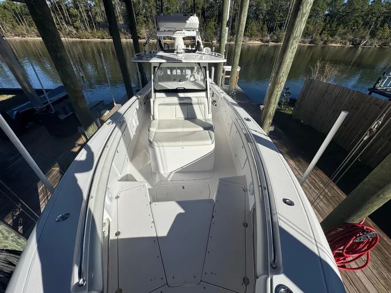 Slide: The Image of 2016 Everglades 435 Center Console boat docked by a serene river. - 29
