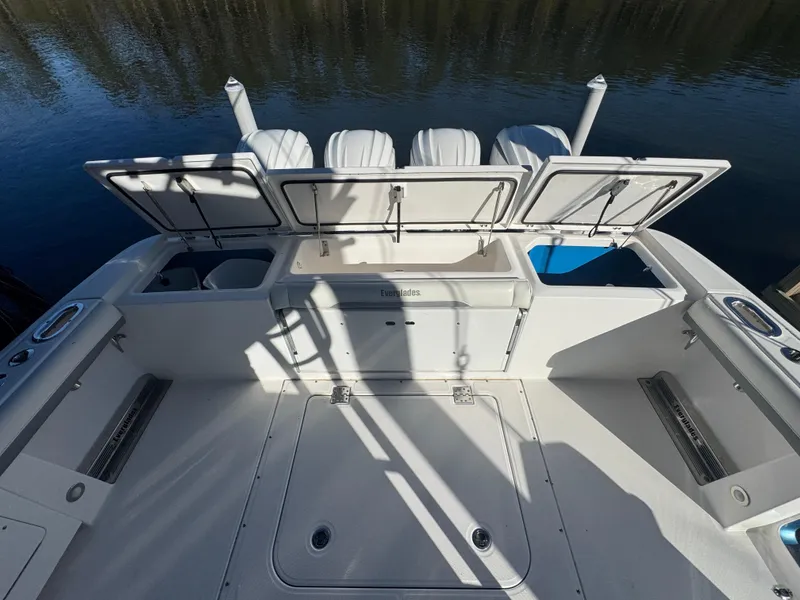 Slide: The Image of 2016 Everglades 435 Center Console boat deck with open storage compartments. - 36
