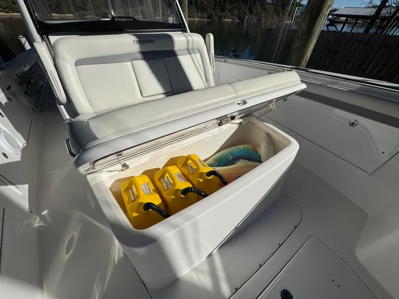 Slide: The Image of Open storage compartment on 2016 Everglades 435 Center Console boat with life jackets inside. - 39